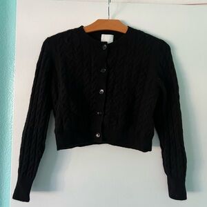 Crop Cashmere blend crew neck cardigan in black with cable texture.